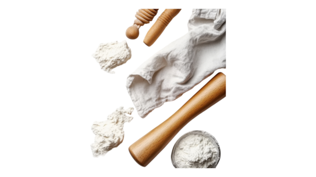 Baking essentials featuring flour, rolling pin, and cloth on a kitchen countertop ready for preparation.