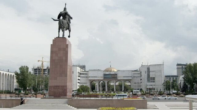 Traffic moves past the statue of Manas in Ala Too Square in the center of Bishkek, Kyrgyzstan.