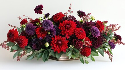 A stunning flower arrangement of red and purple dahlias, perfect for a romantic setting
