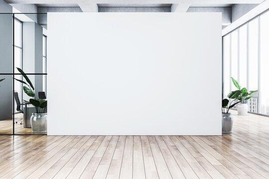 Blank white wall in a modern office interior with wooden floor and glass windows, featuring potted plants and city view backdrop. 3D Rendering