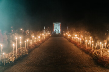 the path of fire torches to the monument in the dark