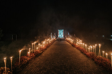 the path of fire torches to the monument in the dark