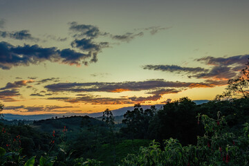 The end of the sunset fills the sky with the colors of an awesome  afterglow, over the western Andean mountains of central Colombia.