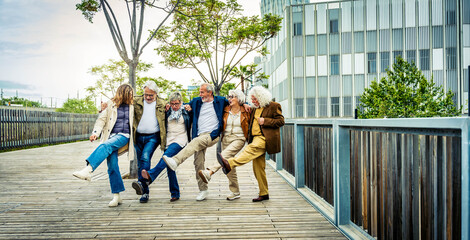 Happy group of senior people having fun walking outdoors