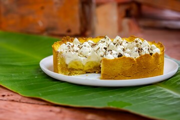 Traditional banoffee cake with banana and caramel sauce filling sprinkled with grated dark chocolate and coffee . English traditional pie
