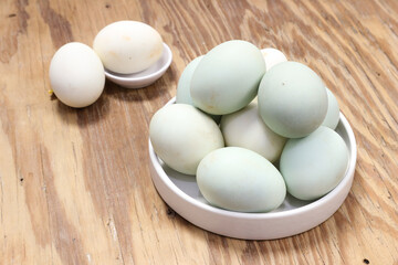 A Collection of Pastel-Colored Eggs on a Rustic Wooden Table