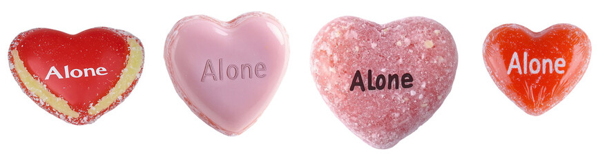 A collection of heart-shaped candies, each imprinted with the word "Alone" in various colors and textures.