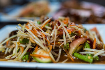 Close up spicy papaya salad with salted crab and fermented fish