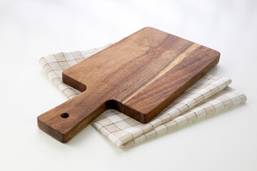 Wooden board and checkered tablecloth on the table