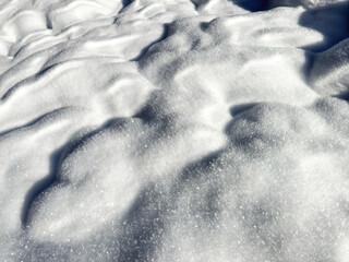 close-up of wavy snow surface. white snow texture. minimalist nature patterns. winter background. white background