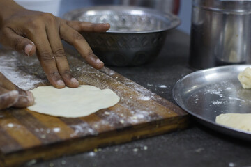 Close-Up of Hands Preparing Dough on Wooden Cutting Board in Rustic Kitchen Setting – Homemade Cooking Concept