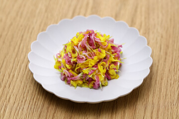 Sweet and sour salad made of yellow and purple chrysanthemum flowers. Japanese cuisine.