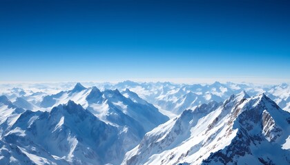 Obraz premium Majestic Snow-Capped Mountain Range under a Clear Blue Sky