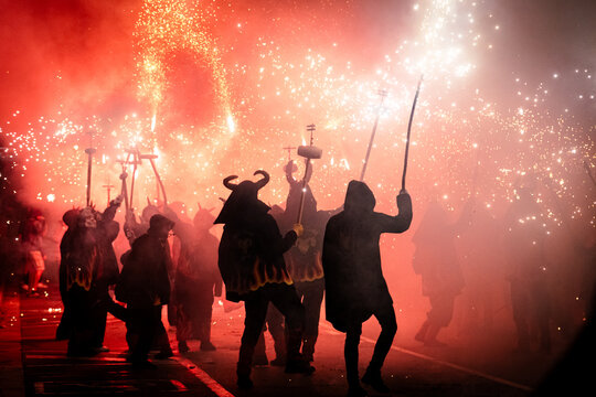 Silhouette of people in masks at a Traditional fire festival, Catalonia, Spain
