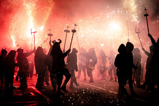 Silhouette of people in masks at a Traditional fire festival, Catalonia, Spain