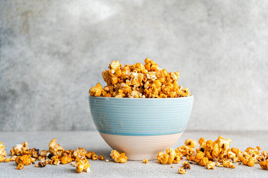 Close-up of an overflowing bowl of Sweet caramel popcorn on a table