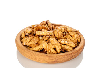 Shelled walnuts on a wooden plate, close-up, isolated on a white background.