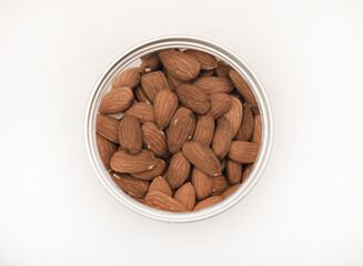 Whole almonds in a jar on a white background.
