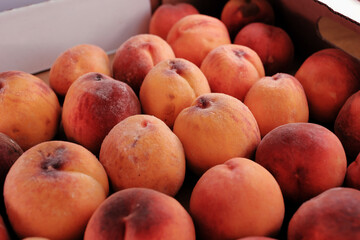 Close View Of Ripe Peaches Inside A Box.