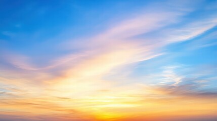 Obraz premium A serene sunset sky with vibrant orange and blue hues, showcasing soft clouds against a backdrop of tranquil twilight.