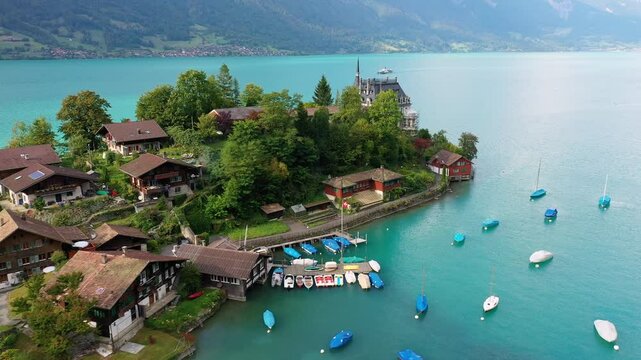 Iseltwald, Switzerland: Aerial drone footage of the famous Iseltwald village by lake Brienz in the Berner Oberland, part of the Swiss alps. 