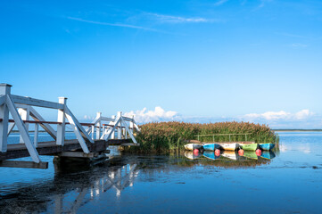 A wooden white bridge and boats at Haapsalu by the Baltic Sea, Estonia