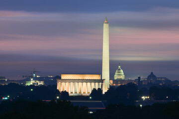 Washington DC cityscape in sunrise with major city monuments including the Lincoln Memorial and...