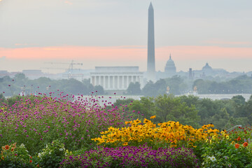 Washington DC cityscape in a foggy sunrise with major city monuments including the Lincoln Memorial and Washington Monument and the Capitol Building