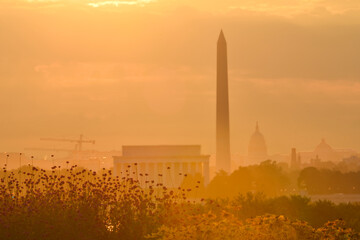 Washington DC cityscape in a foggy sunrise with major city monuments including the Lincoln Memorial and Washington Monument and the Capitol Building
