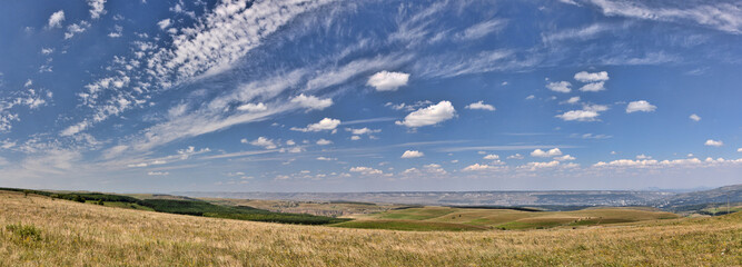 Caucasus foothills under blue sky panorama