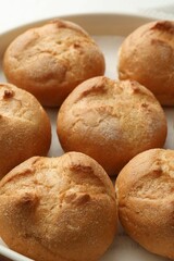Homemade tasty buns in baking dish, closeup