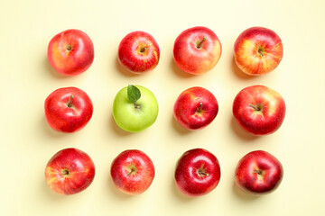 Red apples and green one on beige background, flat lay