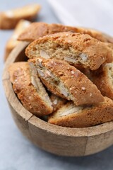 Traditional Italian almond biscuits (Cantucci) in bowl on grey table, closeup