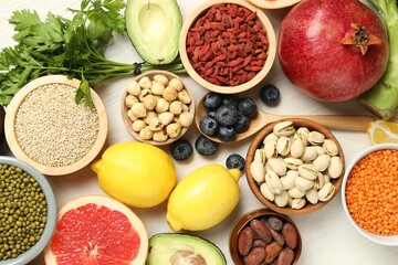 Different superfood products on white table, flat lay