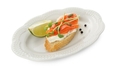 Delicious bruschetta with cream cheese, salmon and piece of lime isolated on white