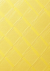Fototapeta premium embossed diamond pattern on soft yellow canvas