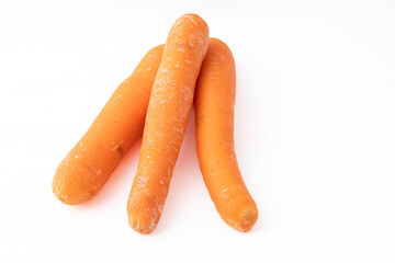 Gennevilliers, France - 01 02 2024: Still life. Close up of three orange Carrots on a white background.