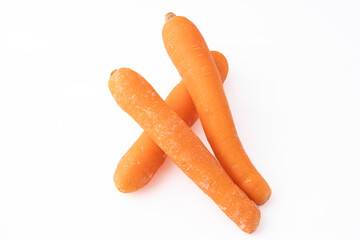 Gennevilliers, France - 01 02 2024: Still life. Close up of three orange Carrots on a white background.