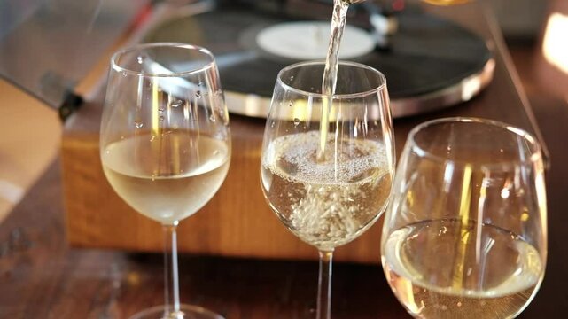 bubbles of French champagne or prosecco in a glass, Pour white wine, champagne or prosecco into a glass from a bottle for an aperitif at home