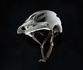 Bicycle white helmet, isolated on black background. Concept of cycling safety.