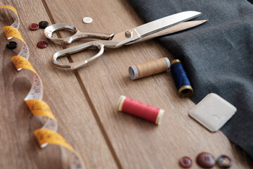 Collection of tailor tools on wooden table