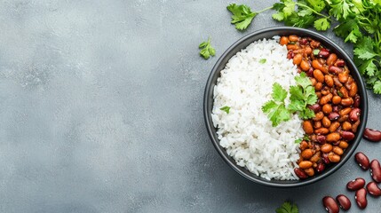Create Budget-Friendly. Bowl of rice and beans topped with fresh cilantro on a textured background.