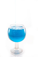 water splash in glass whit blue liquid