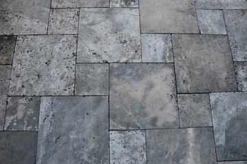 close-up of a Mediterranean terrace floor with different sized square tiles