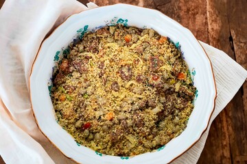 Traditional Brazilian farofa prepared with toasted cassava flour, bacon, onion and typical spices. Brazilian food