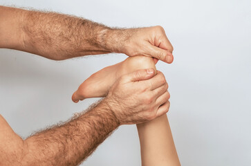 Fototapeta premium Foot massage is performed with emphasis on therapist's hands, which apply pressure to woman's heel.