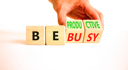 Be productive not busy symbol. Concept words Be productive Be busy on wooden block. Beautiful white...