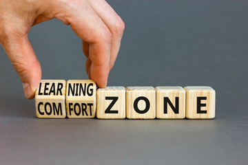 Comfort or learning zone symbol. Concept words Comfort zone Learning zone on wooden cubes. Beautiful grey background. Psychologist hand. Business and comfort or learning zone concept. Copy space.