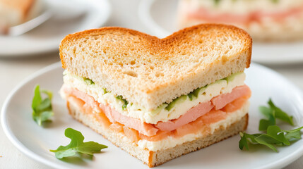 heart shaped sandwich with layers of salmon, cream cheese, and vegetables on plate, perfect for romantic meal
