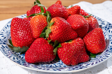 New harvest, plate of ripe red sweet strawberry ready to eat